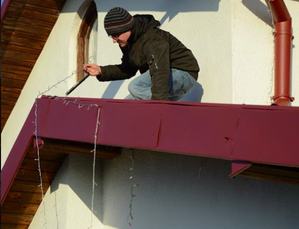 Tomasz on the roof, during the preparation work of the project